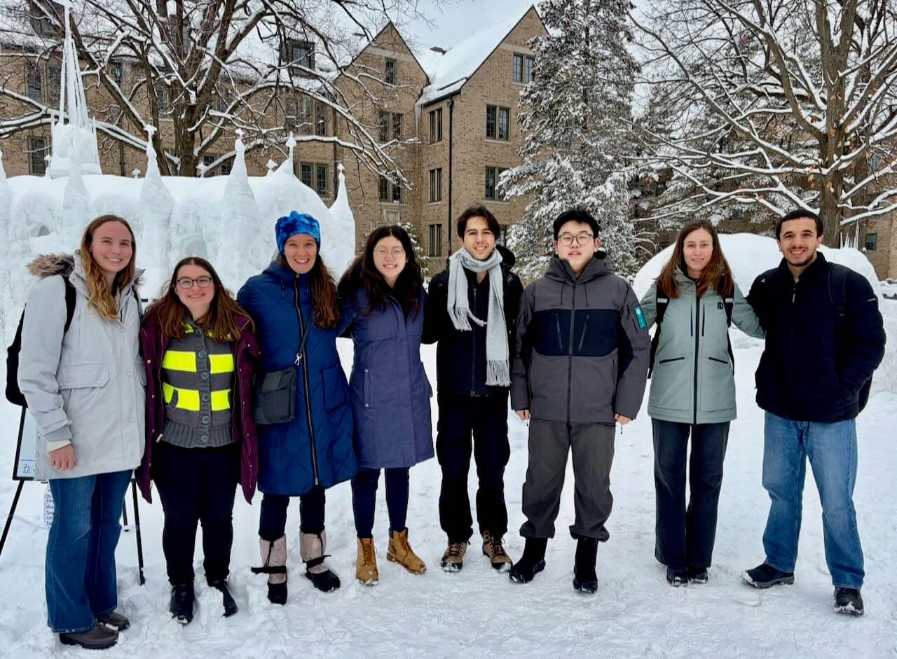 Photo of lab members in front of Notre Dame's ice chapel in Spring 2026