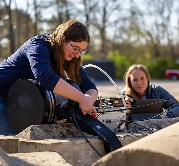 Ciera McFarland makes adjustments to the vine robot at Clay Fire’s training site in June.